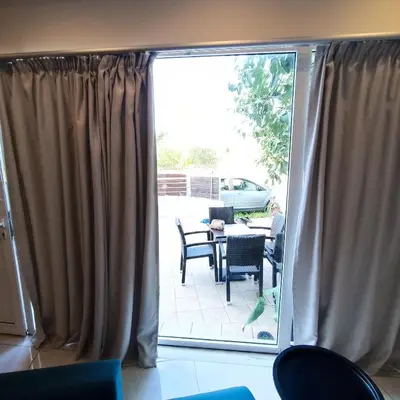 a sliding glass door with a patio with a table and chairs at Drosoula house in Chania Town