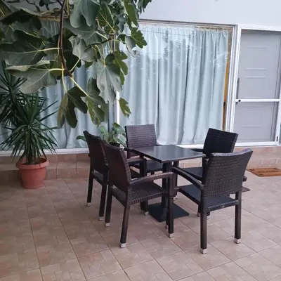 a table and chairs in a room with plants at Drosoula house in Chania Town