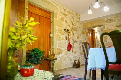 a room with a table and a wooden door at Picturesque Traditional Stone House in Plátanos