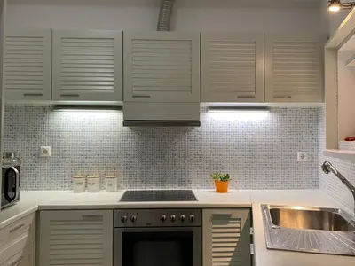 a kitchen with white cabinets and a sink at Be Crete - Zen apartment 2 rooms in Ayiá