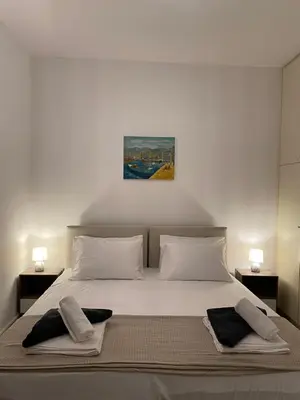 a bedroom with a bed with two towels on it at Be Crete - Zen apartment 2 rooms in Ayiá