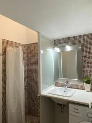 a bathroom with a sink and a shower with a mirror at Be Crete - Zen apartment 2 rooms in Ayiá