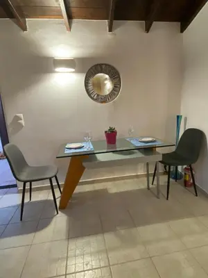 a table with two chairs and a mirror on the wall at Be Crete - Zen apartment 2 rooms in Ayiá