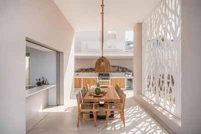a dining room with a wooden table and chairs at JK's 4 in Vamos