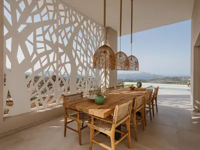 a dining room with a wooden table and chairs at JK's 4 in Vamos