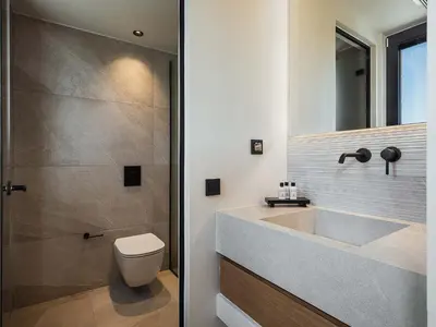 a bathroom with a sink and a toilet and a shower at Rastoni Villa I ''Free'' heated pool & panoramic view in Kalivianí