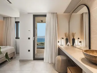 a bathroom with a sink and a large mirror at Rastoni Villa I ''Free'' heated pool & panoramic view in Kalivianí