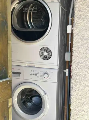 a dryer and a washing machine in a wall at Perfect home away from home in Palio Gerani