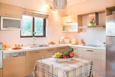 a kitchen with a table with a bowl of fruit on it at Villa Gianna in Almirida