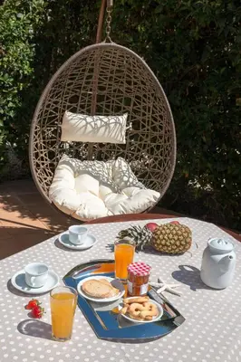 a table with a plate of food and orange juice at Villa Gianna in Almirida