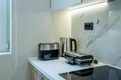 a kitchen with a coffee maker and a toaster on a counter at Hypnos Luxury Lodgings in Chania Town