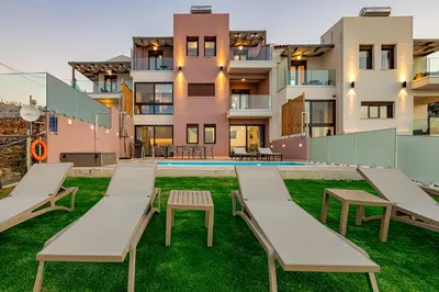 a view of a building with benches and a pool at Villa Mari mini in Kondópoula