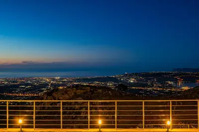 a view of a city from a hill at night at Villa Mari mini in Kondópoula