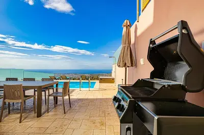 a grill with a table and a table and a dining room at Villa Mari mini in Kondópoula