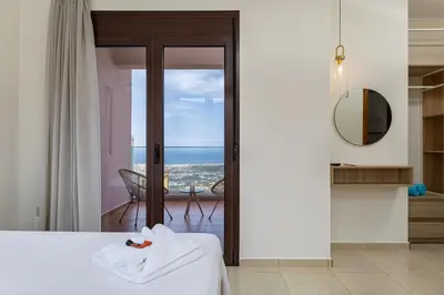 a bedroom with a bed and a view of the ocean at Villa Mari mini in Kondópoula