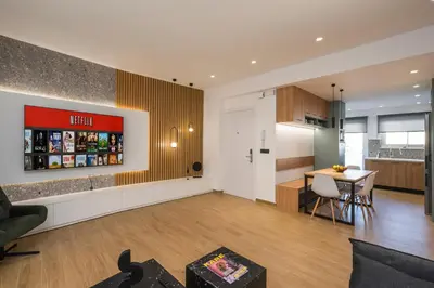 a living room with a kitchen and a table at Be Crete - White Pearl in Chania Town