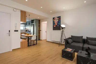 a living room with a couch and a kitchen at Be Crete - White Pearl in Chania Town