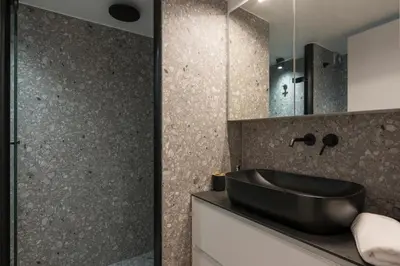 a bathroom with a black sink and a mirror at Be Crete - White Pearl in Chania Town