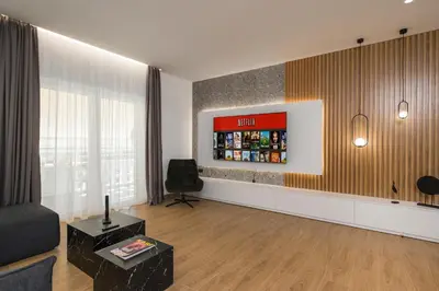 a living room with a couch and a tv at Be Crete - White Pearl in Chania Town