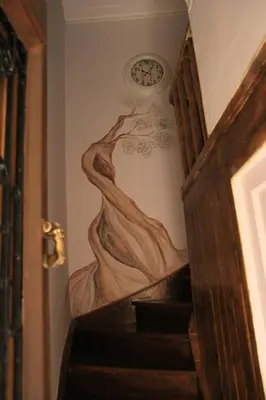 a painting of a woman on a wall with a clock at Elia Portou Rooms in Chania Town
