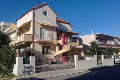 a white house with a fence in front of it at QUIET NEW Apartment-5' to the beach, 15' to center in Chania Town