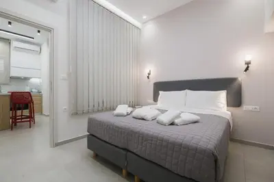 a bedroom with a bed with two pillows on it at Peris 4 with Yard steps to Old Town - AC, Wifi in Chania Town
