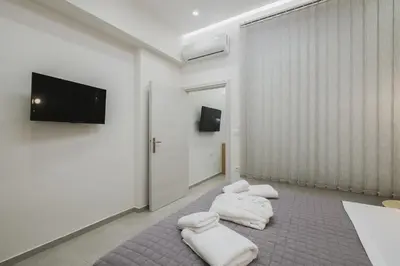 a room with three white towels on a carpet at Peris 4 with Yard steps to Old Town - AC, Wifi in Chania Town