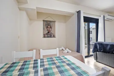 a bedroom with a bed and a room with a window at Dimi's Studio Center in Chania in Chania Town