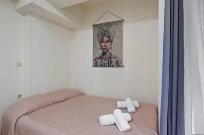 a bedroom with a bed with two towels on it at Dimi's Studio Center in Chania in Chania Town