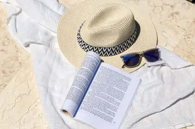 a straw hat and a book and a hat and sunglasses at Villa Shell in Tersanas