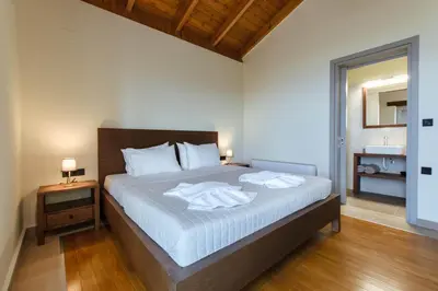 a bedroom with a bed with two towels on it at Villa Kalithea in Kissamos
