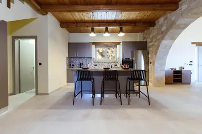 a kitchen with a table and chairs in a room at Villa Kalithea in Kissamos