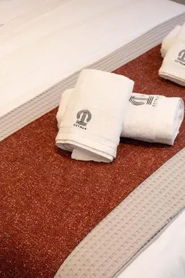 a couple of towels sitting on top of a bed at Citrus Daliani Rooms in Chania Town