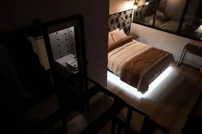 a small bedroom with a bed and a mirror at Citrus Daliani Rooms in Chania Town