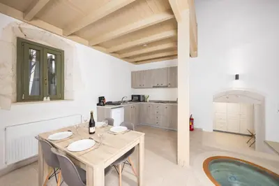 a kitchen and dining room with a table and chairs at Villa Nafsika in Vamos