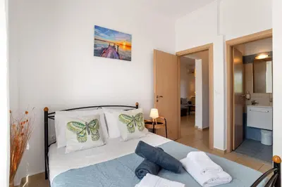 a bedroom with a bed with towels on it at Almyrida Bay View House III BY APOKORONAS-VILLAS in Almirida