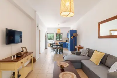 a living room with a couch and a table at Almyrida Bay View House III BY APOKORONAS-VILLAS in Almirida