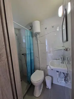 a bathroom with a toilet and a sink at Stefanos Garden3 in Arménoi