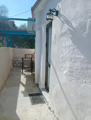a door to a building with a lamp on it at Stefanos Garden3 in Arménoi