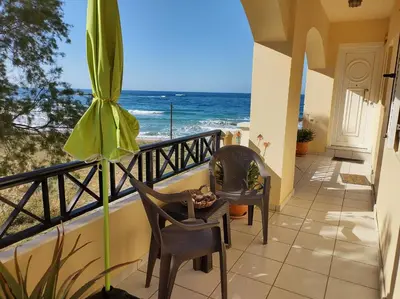 a balcony with chairs and a view of the ocean at Sky & Sea 3 in Kato Daratso