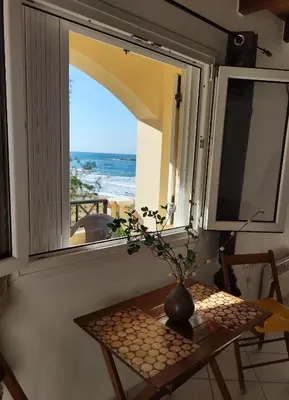 a table and a window with a view of the ocean at Sky & Sea 3 in Kato Daratso
