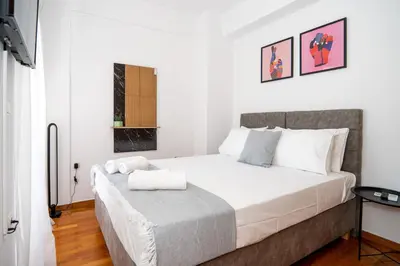 a bedroom with a large white bed in a room at CityNest apartment in Chania Town