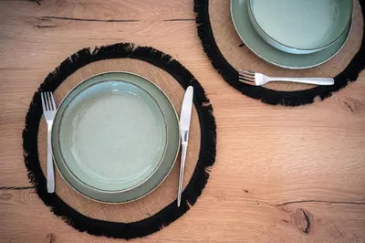 two plates and utensils on a wooden table at CityNest apartment in Chania Town