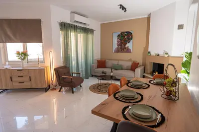 a living room with a table and a couch at CityNest apartment in Chania Town