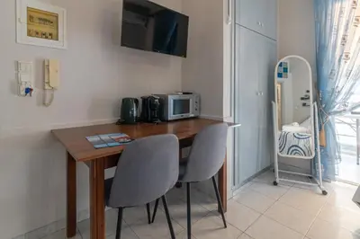 a kitchen with a table with two chairs and a microwave at Alena Apartments in Chania Town