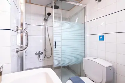 a bathroom with a shower and a toilet and a sink at Alena Apartments in Chania Town