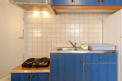 a kitchen with blue cabinets and a sink at Alena Apartments in Chania Town