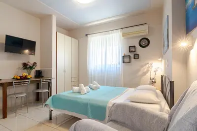 a bedroom with a bed and a table in a room at Alena Apartments in Chania Town
