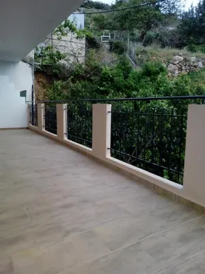 a balcony with a black and white fence at Kleio Studios in Ravdhoúkha