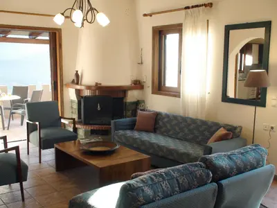 a living room with a couch and a table at Aori Hillside Villa in Kántanos